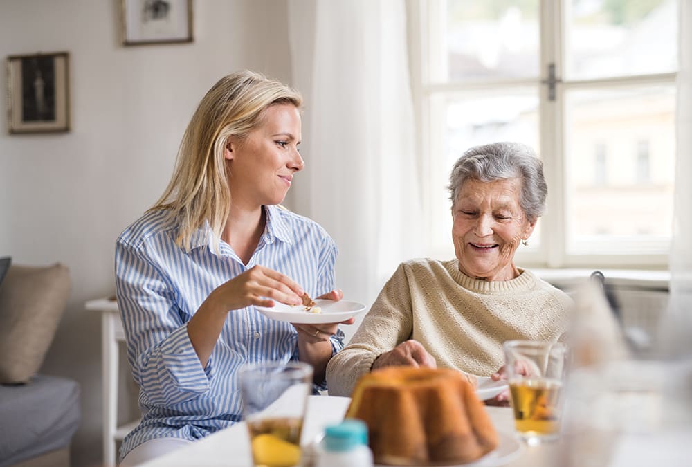 Image of two women eating in a hospice environment